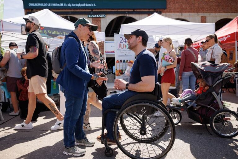 State Representative Josh Turek, a Democrat from Iowa and US Senate candidate, speaks with attendees while campaigning at the Des Moines Farmers Market in Des Moines, Iowa, US, on Saturday, May 23, 2026.