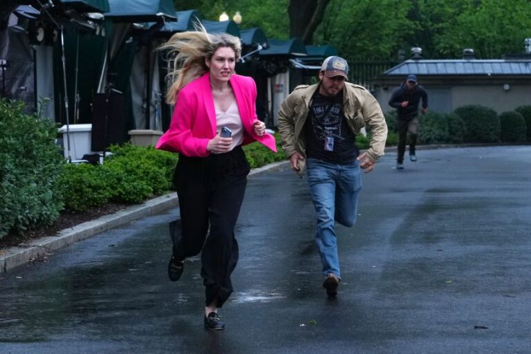 Members of the media clear the North Lawn following reports of gunfire on May 23.