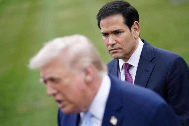 Secretary of State Marco Rubio listens as President Donald Trump speaks to members of the media, as Trump departs the White House for Florida, on March 20.