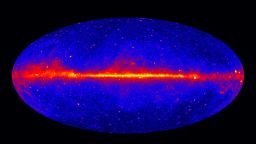 The Fermi LAT 60-month image, constructed from front-converting gamma rays with energies greater than 1 GeV. The most prominent feature is the bright band of diffuse glow along the map's center, which marks the central plane of our Milky Way galaxy. The gamma rays are mostly produced when energetic particles accelerated in the shock waves of supernova remnants collide with gas atoms and even light between the stars. Hammer projection.