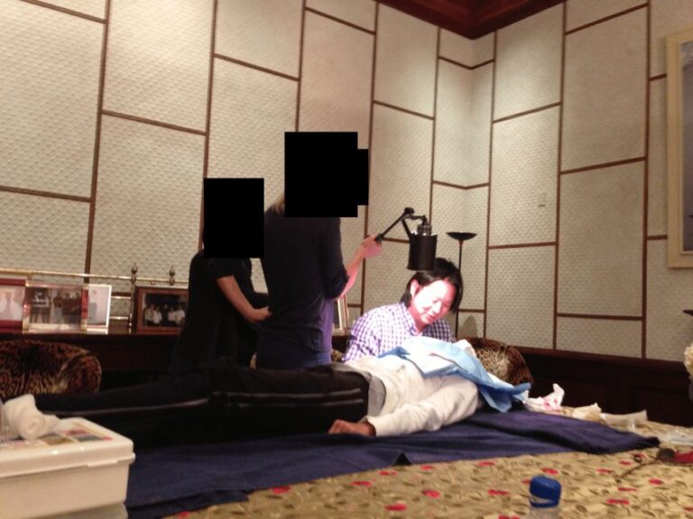 This undated photo in the Epstein files shows Jess Ting, a plastic surgeon at Mount Sinai, inside of Epstein’s home standing over a patient lying on a table.