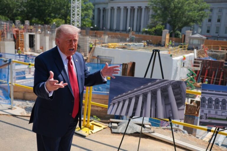 President Donald Trump speaks to the media alongside posters of his proposed White House ballroom amid construction at the White House on May 19, 2026.