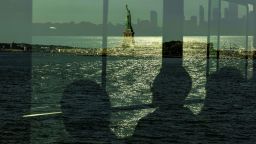 TOPSHOT - People riding the ferry to Ellis Island for a Naturalization Ceremony on Citizenship Day past the Statue of Liberty in New York, on September 17, 2022. (Photo by Alex Kent / AFP) (Photo by ALEX KENT/AFP via Getty Images)