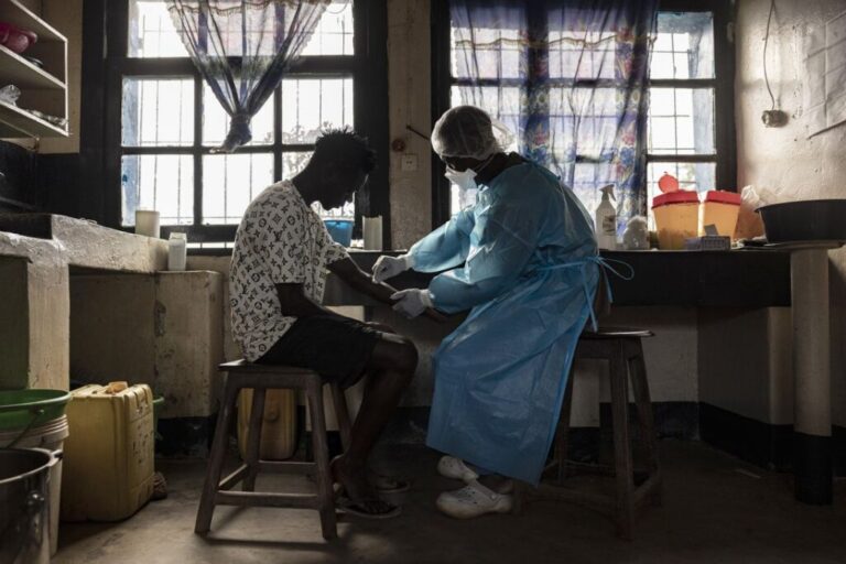 A patient prepares to have blood drawn for a test in a hospital in Mongbwalu, Ituri Province, Democratic Republic of Congo, as part of the Ebola response.