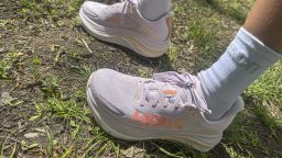 A woman wearing Hoka Gaviota 6 sneakers.