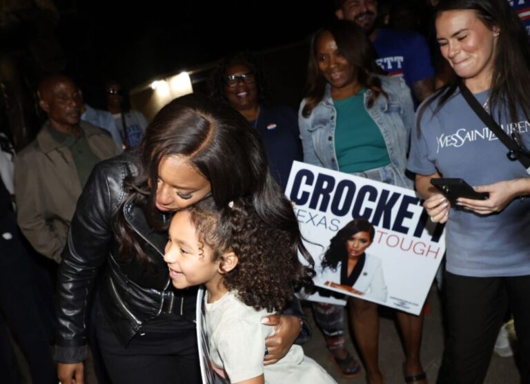Rep. Jasmine Crockett greets seven year-old supporter Cataleya Davis outside a polling station on February 27, 2026 in Dallas, Texas.