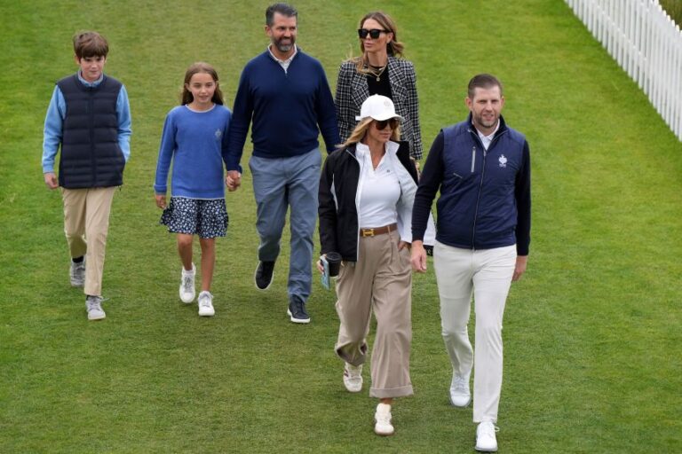 Donald Trump jr., rear center, with partner Bettina Anderson and the president's grandchildren, Spencer and Chloe, as well as Eric Trump and Lara Trump, arrive to attend an opening ceremony for Trump International Golf Links near Aberdeen, Scotland, on July 29, 2025.