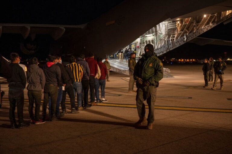 In this handout provided by the US Department of Defense, US Customs and Border Protection Agents guide immigrants onboard a C-17 Globemaster III at the Tucson International Airport in Arizona on January 23, 2025.