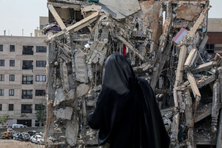 People look at sites targeted by US-Israeli strikes in Tehran, Iran, during a tour by foreign diplomatic representatives and members of the media on April 20.