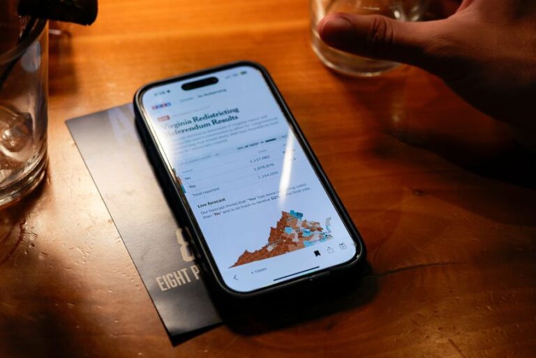 A Virginia resident attends an election night watch party in Arlington, as they await results of Virginia’s congressional redistricting vote on April 21.