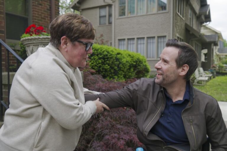 Theresa Weeks, an Iowa resident, speaks with State Representative Josh Turek, a Democratic candidate for US Senate.