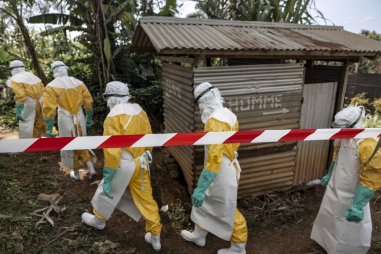 Doctors Without Borders teams wearing full protective equipment reinforce perimeter barriers around a restricted Ebola isolation zone and basic hygiene facilities, including toilets designated for suspected Ebola patients, at the General Referral Hospital of Mongbwalu on May 26, in Mongbwalu, Democratic Republic of Congo.