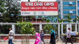 This photograph taken on April 23, 2025 shows people walking past the 250 Bedded TB Hospital, formerly funded by the US development agency USAID in Dhaka.