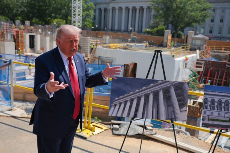 President Donald Trump speaks to the media alongside posters of his proposed White House ballroom amid construction at the White House on May 19, in Washington, DC.