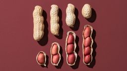 Peeled Peanuts Collection on Red Colored Background Close-up View.