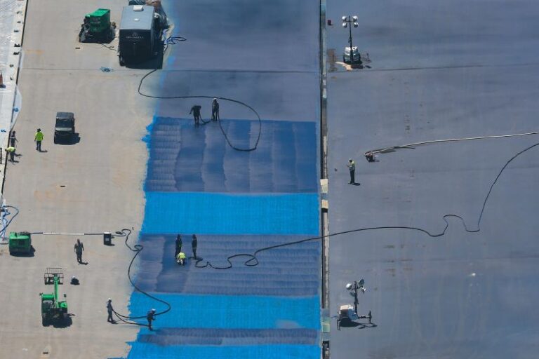 A view of the application of blue sealant onto the bottom of the Lincoln Memorial Reflecting Pool on the National Mall is seen from the Washington Monument on May 29.