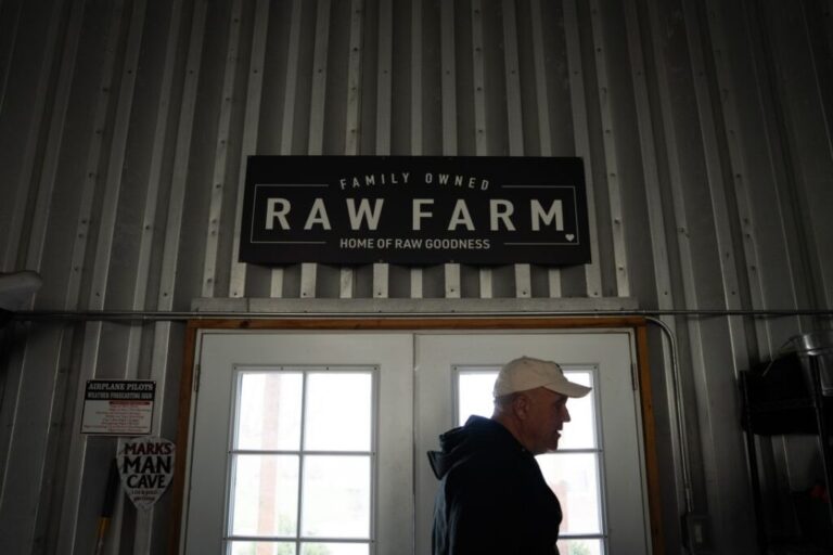 McAfee exits the hangar where his airplane is stored at Raw Farm.