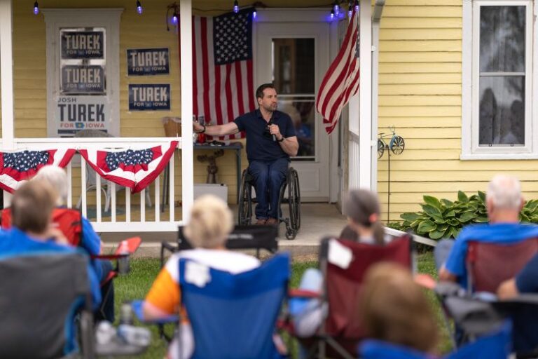 Josh Turek speaks to guests during a campaign event at the Noethe family farm in Westide, Iowa, on May 29.