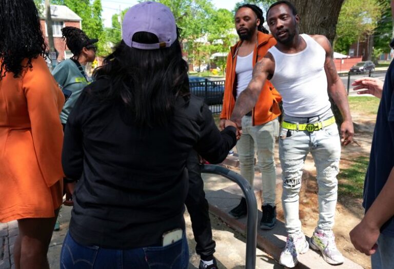 From left, DC mayoral candidate Janeese Lewis George shakes hands with a man after chatting with him about her policy ideas on April 18, 2026.