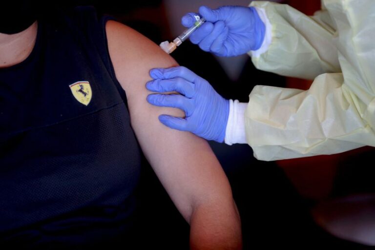 Erica Sanchez-Lerma (right) of ¡Salud! Services gives a tetanus, diphtheria and pertussis vaccine to farmworker Asuncion Martinez-Vasquez at Bethel Heights Vineyard near Salem, Oregon, in 2020.