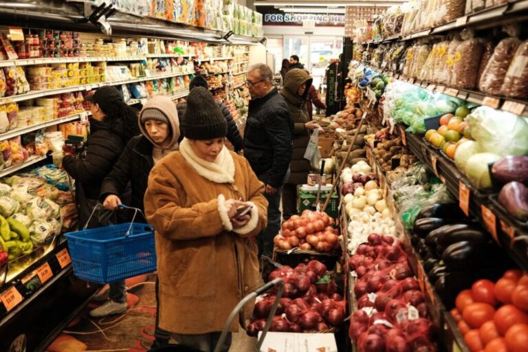 People shop at a local supermarket in the Sugar Hill neighborhood in the Manhattan borough of New York on April 9.
