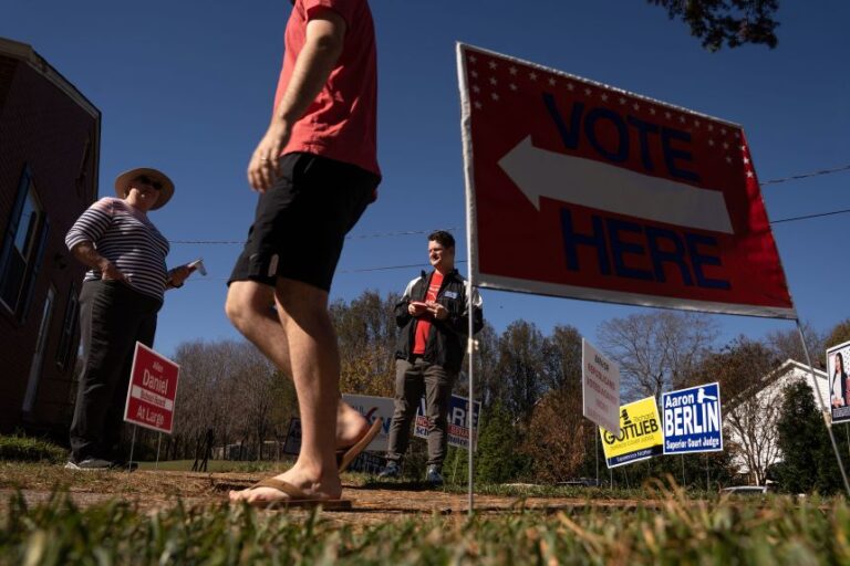 CLEMMONS, NC - NOVEMBER 08: A voter walks past people handing out election literature on November 8, 2022 in Clemmons, North Carolina. After months of candidates campaigning, Americans are voting in the midterm elections to decide close races across the nation. (Photo by Sean Rayford/Getty Images)