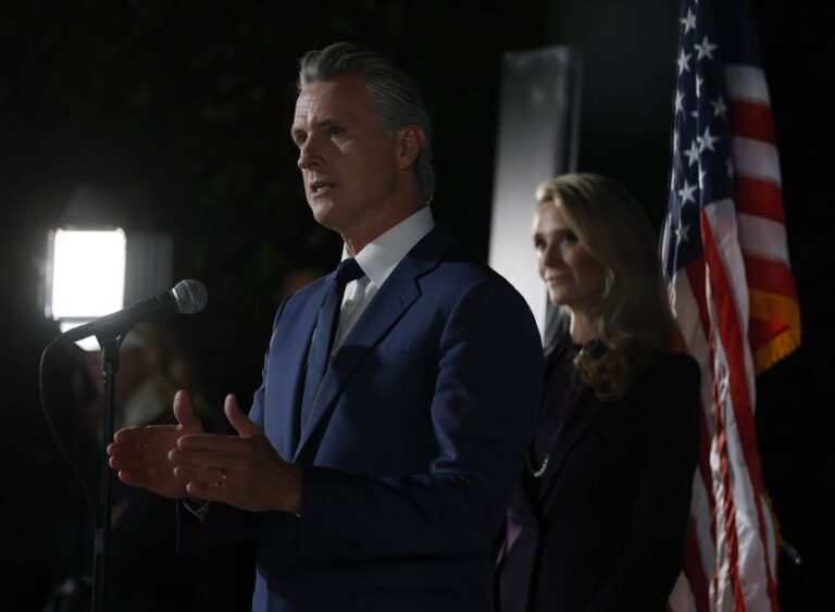 SACRAMENTO, CALIFORNIA - NOVEMBER 04: California Gov. Gavin Newsom (L) speaks as his wife Jennifer Siebel Newsom (R) looks on during an election night gathering at the California Democrats headquarters on November 04, 2025 in Sacramento, California. California voters approved Proposition 50, a measure that will replace the state’s current congressional district map with new, legislature-drawn lines from 2026 through 2030. (Photo by Justin Sullivan/Getty Images)