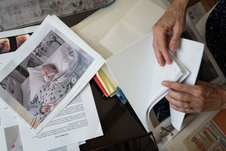 Mary McGonigle-Martin looks through old articles and documents she has saved. Nearly 20 years ago, her son, Chris, contracted an E. coli infection after consuming unpasteurized milk.