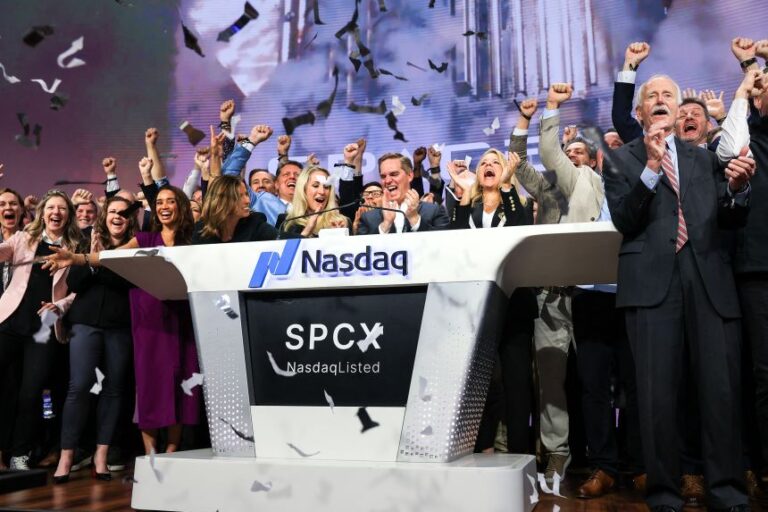 SpaceX executives celebrate as they ring the opening bell at the Nasdaq MarketSite to mark the company's initial public offering in New York City on June 12.