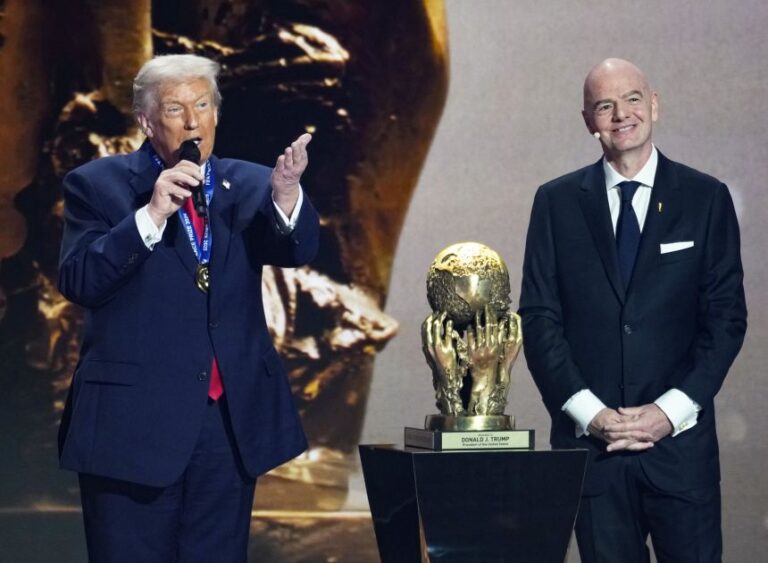 President Donald Trump speaks next to FIFA President Gianni Infantino after the newly established FIFA Peace Prize was given to him during the 2026 World Cup official draw in Washington on December 5, 2025.