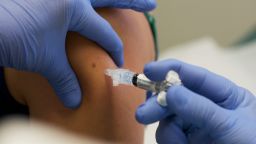 IOWA CITY, IA - AUGUST 11: Marisa Grunder, 27 of Wilton, Iowa, is given a shot during trials of an H1N1 vaccine, developed by CSL of Australia, at University of Iowa Health Care, the University's medical center, on August 11, 2009 in Iowa City, Iowa. The university's medical center is one of 8 trial sites across the nation conducting human studies on the new vaccine which is looking at optimal dosage levels for a variety of age groups. (Photo by David Greedy/Getty Images)