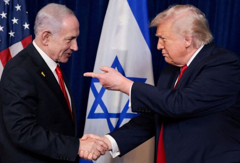 President Donald Trump points his finger towards Israeli Prime Minister Benjamin Netanyahu as they shake hands during a press conference at Mar-a-Lago in Palm Beach, Florida, in December.