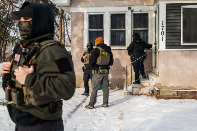 Federal law enforcement agents outside a private residence in St. Paul, Minnesota,on January 18, 2026.
