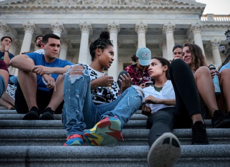 Ocasio-Cortez talks with Kamala Lyles, 20, during a demonstration outside the US Capitol to protest the expiration of the federal moratorium on residential evictions, in Washington, DC, in 2021.