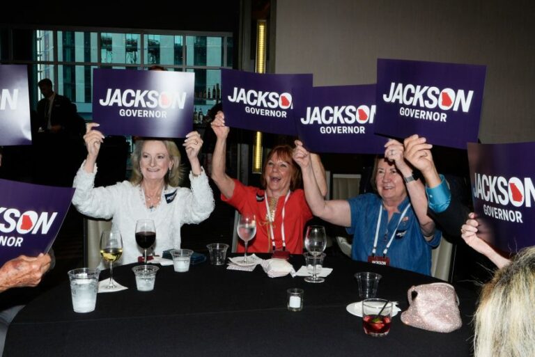 Supporters hold signs during a primary election night party for Georgia gubernatorial candidate Rick Jackson on May 19 in Atlanta.