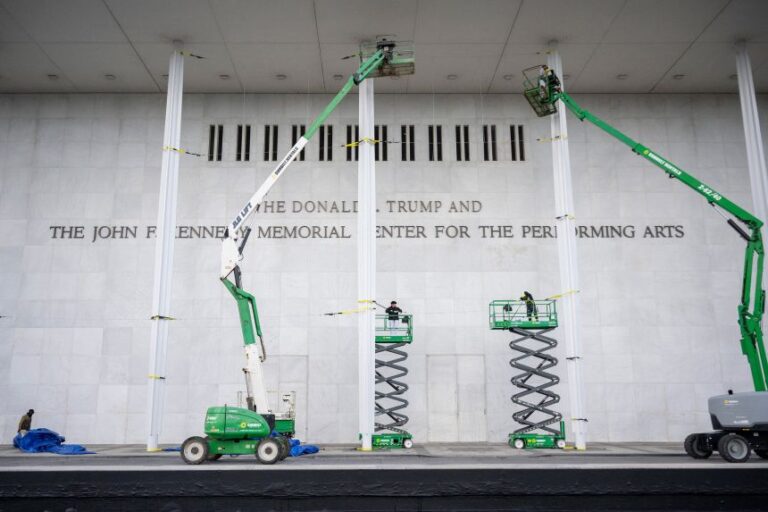 Workers are seen outside The John F. Kennedy Memorial Center for the Performing Arts after they updated the signage after the center was renamed in honor of US President Donald Trump on December 19, 2025, in Washington, DC.