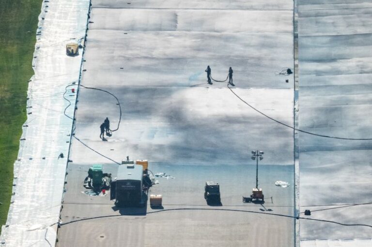 Workers paint the bottom of the Lincoln Memorial Reflecting Pool on the National Mall, as seen from the Washington Monument on May 17, 2026 in Washington, DC.