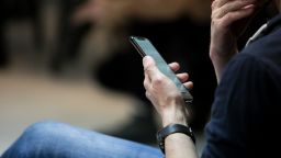 01 man scrolling phone STOCK