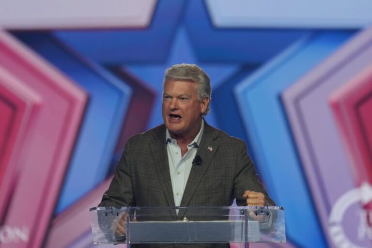 Rep. Mike Collins speaks during Turning Point USA's AmericaFest 2025, on Saturday, December 20, 2025, in Phoenix.