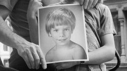 Stanly and Ari Patz hold a photo of Etan Patz at their Manhattan home in New York in May 1985.