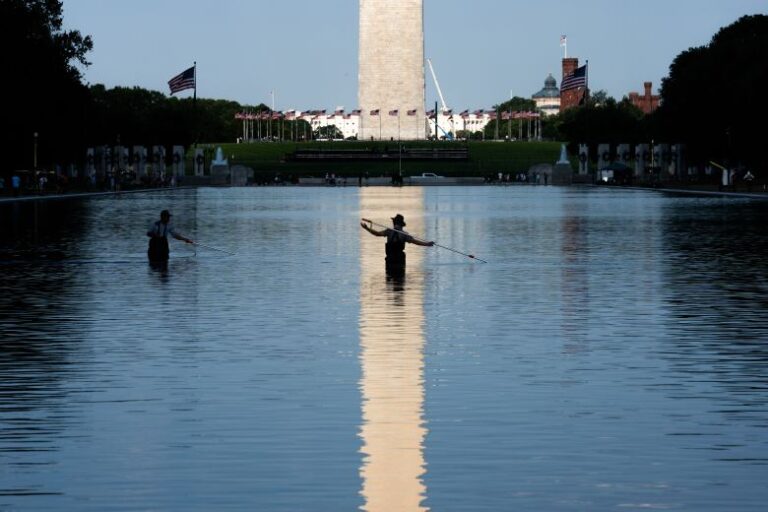 Workers clean algae from the Lincoln Memorial Reflecting Pool after it was painted blue in Washington, DC, US, on Wednesday, June 17, 2026.