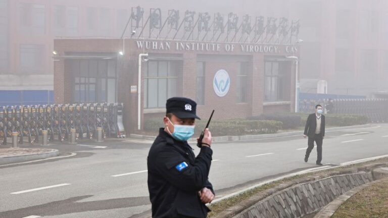 Security personnel stand outside Wuhan Institute of Virology as members of the World Health Organization (WHO) team tasked with investigating the origins of the coronavirus disease (COVID-19) arrive for a visit, in Wuhan, Hubei province, China February 3, 2021. REUTERS/Thomas Peter