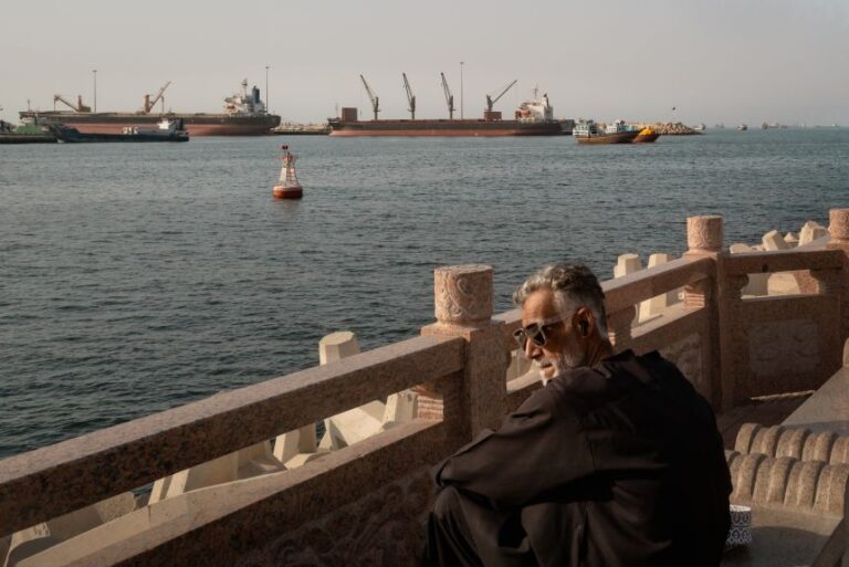 A man observes oil tankers, general cargo ships, bulk carriers and fishing boats anchored in the waters off Muscat near the Strait of Hormuz on June 18, 2026 in Muscat, Oman. The US and Iran have an agreement to bring an end to the war and open the Strait of Hormuz, a vital waterway through which vast amounts of oil and gas are transported every day.