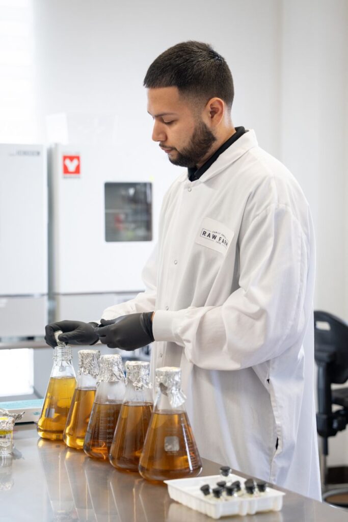 Laboratory technician Jonathan Robles prepares broth to test for a specific pathogen at Raw Farm.