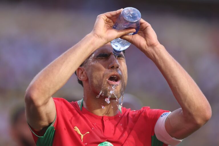 Achraf Hakimi of Morocco pours water over himself to cool down in the heat. Fans and players alike are encouraged to stay hydrated during World Cup matches.