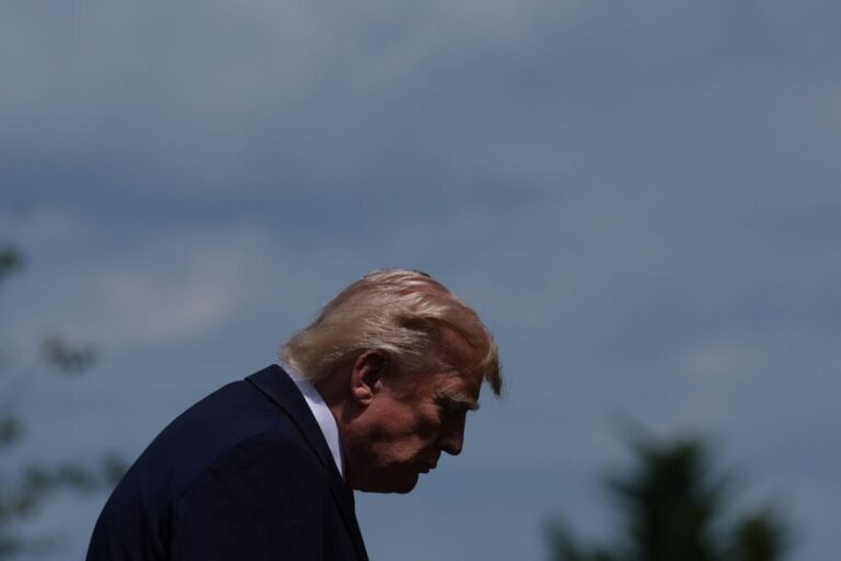 President Donald Trump walks off the podium after a group photo of G7 leaders and invited nations during the G7 summit in Evian-les-Bains, France, on Tuesday.
