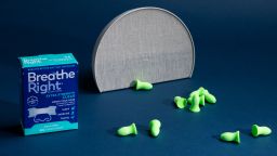 Nasal strips, ear plugs and an alarm clock displayed next to each other.