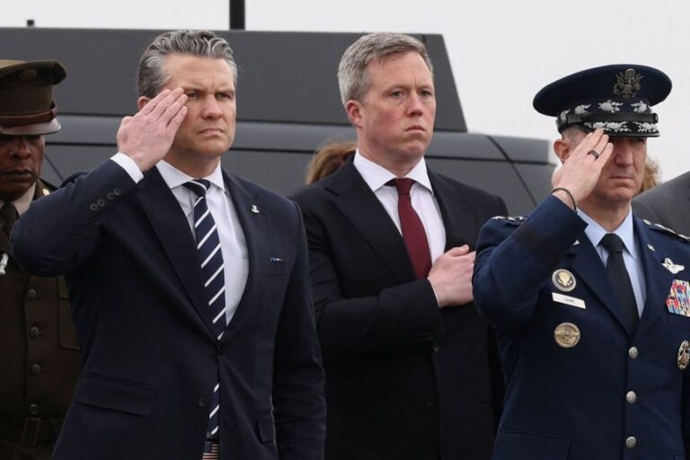 US Defense Secretary Pete Hegseth, US Army Secretary Daniel Driscoll, and Chairman of the Joint Chiefs of Staff General Dan Caine pay their respects during a dignified transfer of the remains of six US Army service members of the 103rd Sustainment Command, who were killed in Kuwait, Major Jeffrey O'Brien, Capitain Cody Khork, Chief Warrant Officer 3 Robert Marzan, Sergeant 1st Class Nicole Amor, Sergeant 1st Class Noah Tietjens and Sergeant Declan Coady, amid the U.S.-Israeli conflict with Iran, at Dover Air Force Base in Dover, Delaware, US, on March 7.