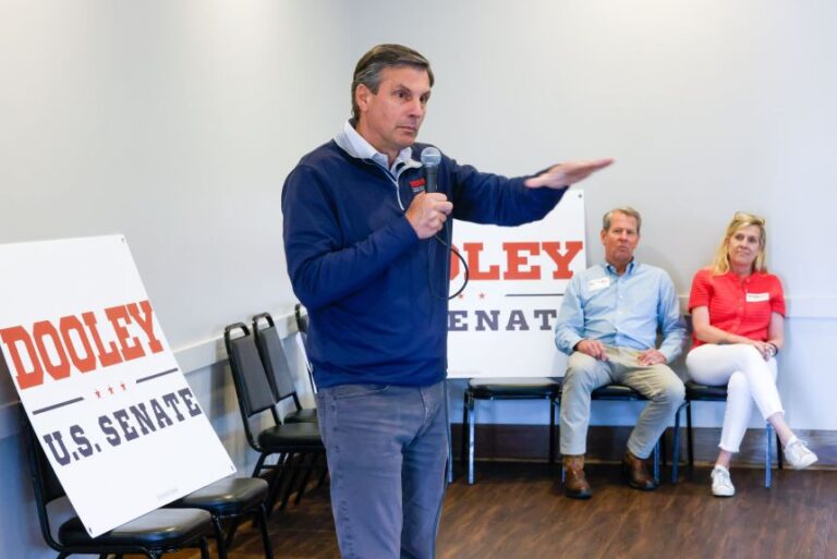 Republican US Senate candidate Derek Dooley speaks at a campaign stop at Farmview Market in Madison on May 8, 2026, as Gov. Brian Kemp and his wife Marty look on.