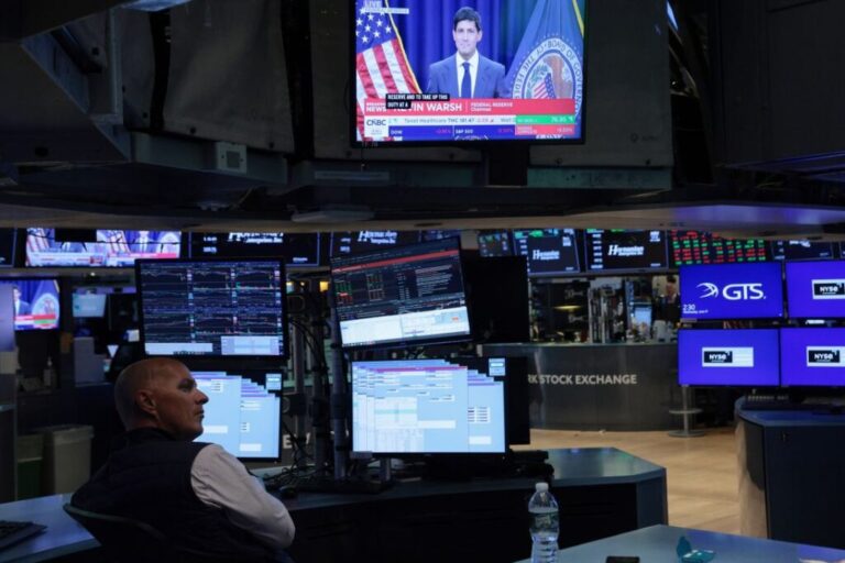 A television displays a Kevin Warsh, chairman of the Federal Reserve, press conference as traders work on the floor of the New York Stock Exchange during afternoon trading on June 17, 2026 in New York City.